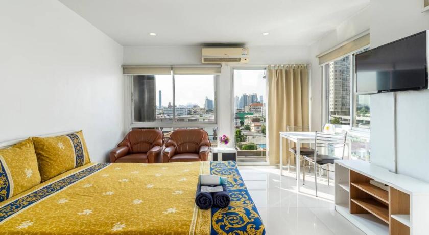 a hotel room with a bed, table and window, Right Place Sathorn in Bangkok