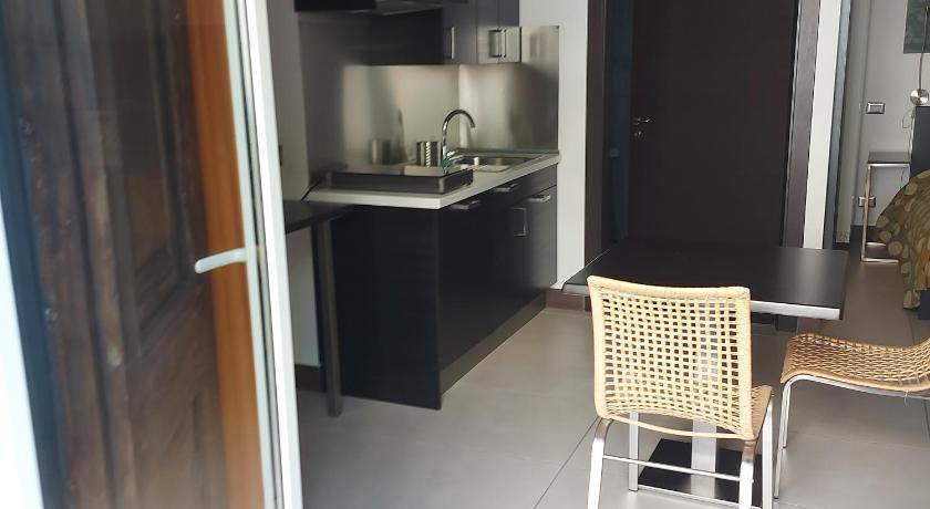 a kitchen with a table and chairs in it, Residenza Pizzofalcone in Naples