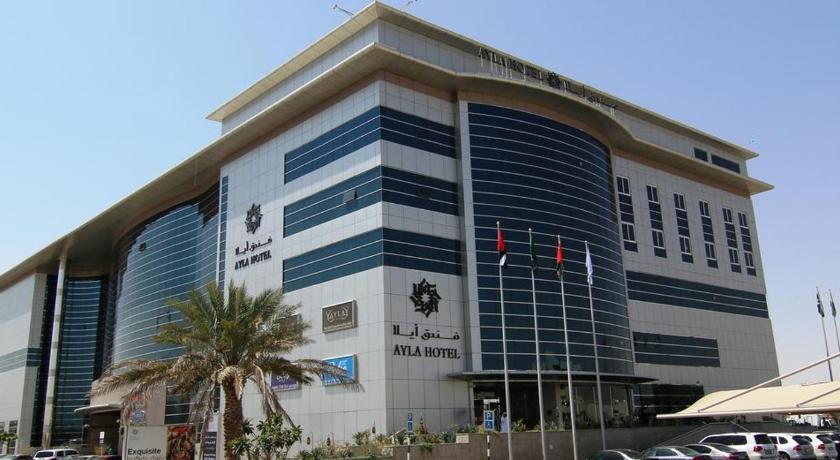 a large building with a large clock on the front of it, Ayla Hotel in Al Ain