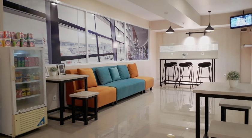 a living room filled with furniture and a tv, Titanium Express Homtel in Jakarta