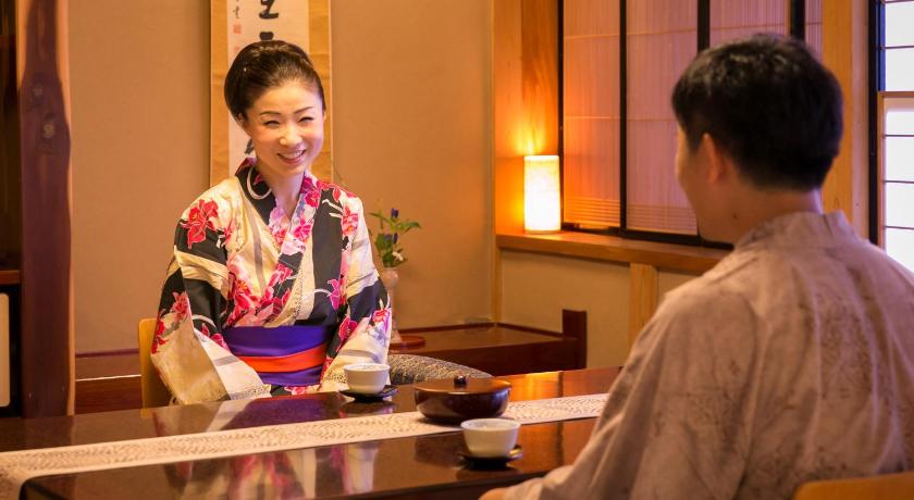 a man and woman are sitting at a table, Takanosukan in Murakami
