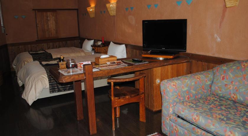 a living room filled with furniture and a computer, Resonate Club Kuju in Kokonoe