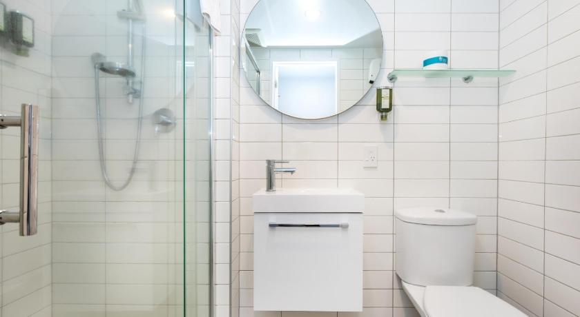 a bathroom with a toilet, sink, and shower, Southwark Apartments in Christchurch