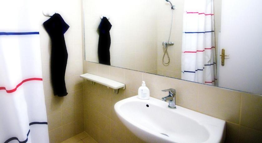 a bathroom with a sink and a mirror, CentrAlom Apartman in Pecs