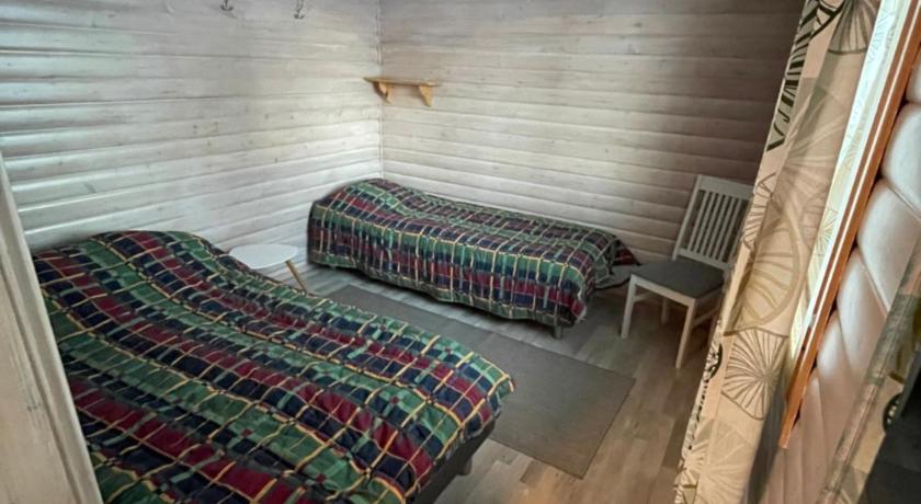 a bedroom with a bed and a desk in it, Youth Center Vasatokka in Inari
