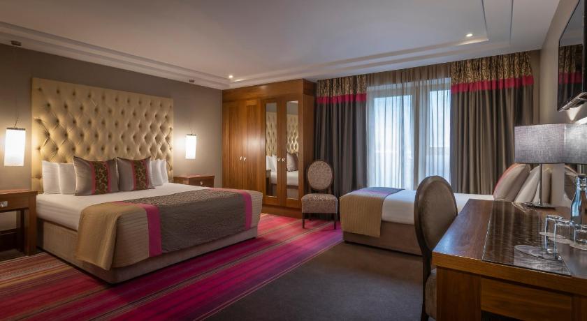 a hotel room with two beds and a table, The Maritime in Bantry
