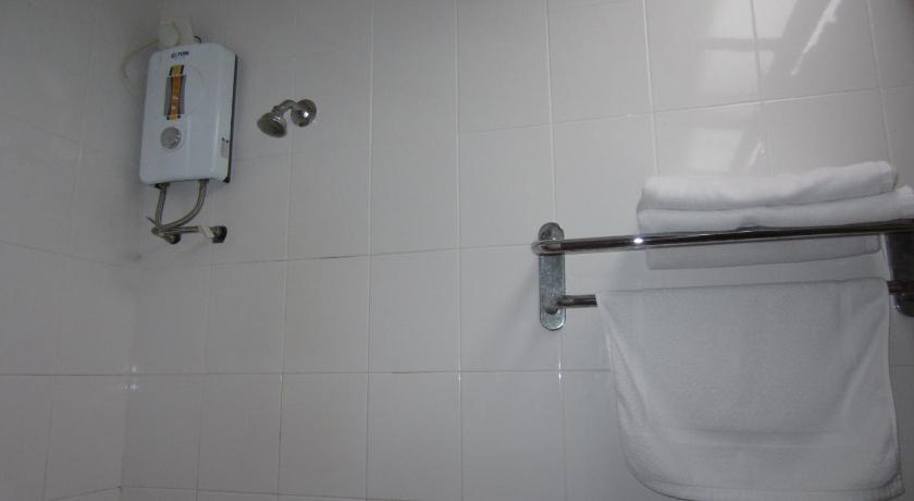 a white toilet sitting next to a white sink, Sunset Beach Resort in Langkawi