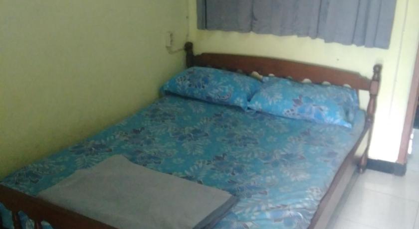 a bed sitting in a room next to a window, Dhika Adventure - Hostel & Travel in Probolinggo