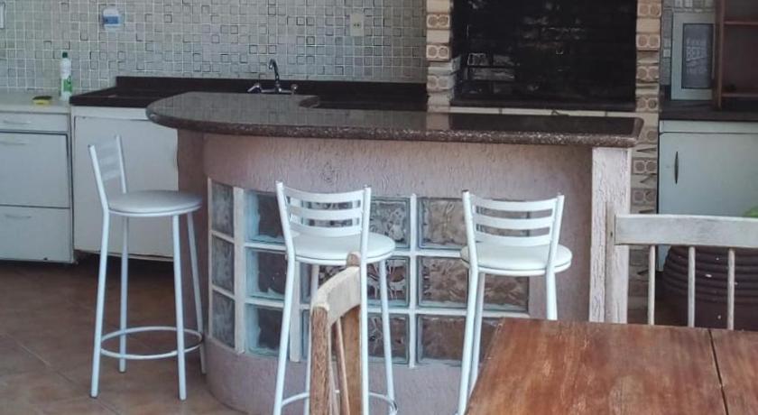 a dining room table with a fireplace and chairs, Pousada do Bosque in Rio Branco