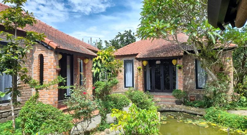 a large building with a large window in front of it, Tam Tinh Vien Homestay in Hue