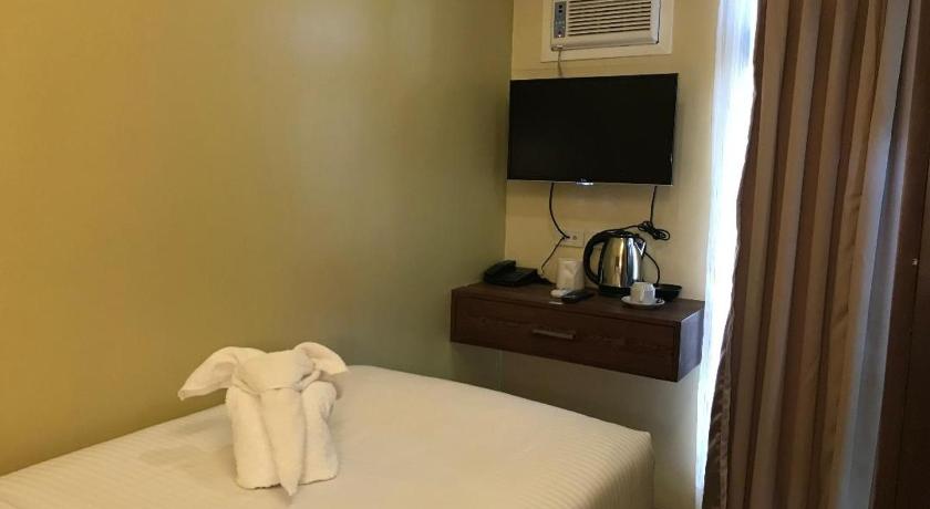 a hotel room with a television and a bed, Treasure Island Hotel With Mini Water Adventure in Masbate
