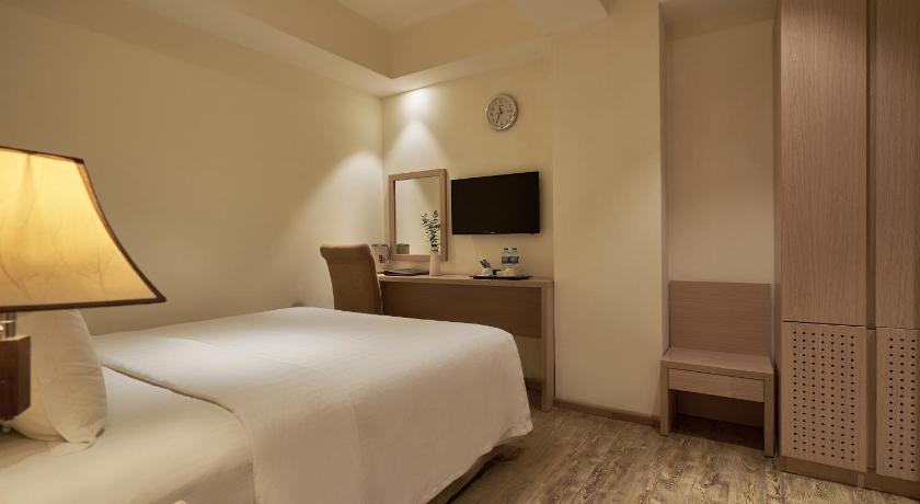 a bedroom with a bed and a television, Sky Gem Hotel Sora in Ho Chi Minh City