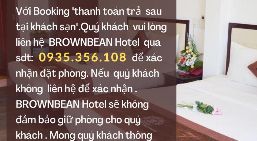 a hotel room with a bed and a clock on the wall, Brown Bean Hotel - 2/9 Street in Da Nang