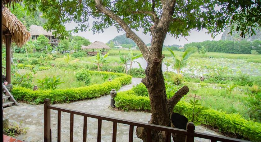 a view from a balcony of a park with trees, Muong Village Ninh Binh in Ninh Bình