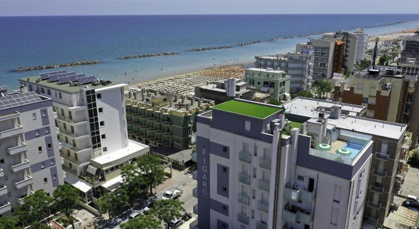a city with a large building on top of it, Amadei Hotel Figaro & Apartments in Pesaro