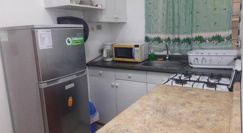 a kitchen with a refrigerator and a microwave, Suites & Apartments San Benito - Flats in San Salvador