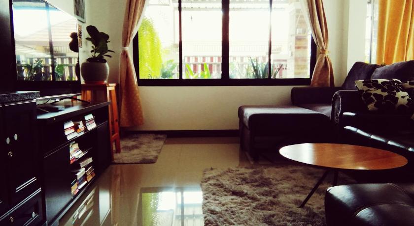a living room filled with furniture and a window, Wilderness Bed And Breakfast in Rayong