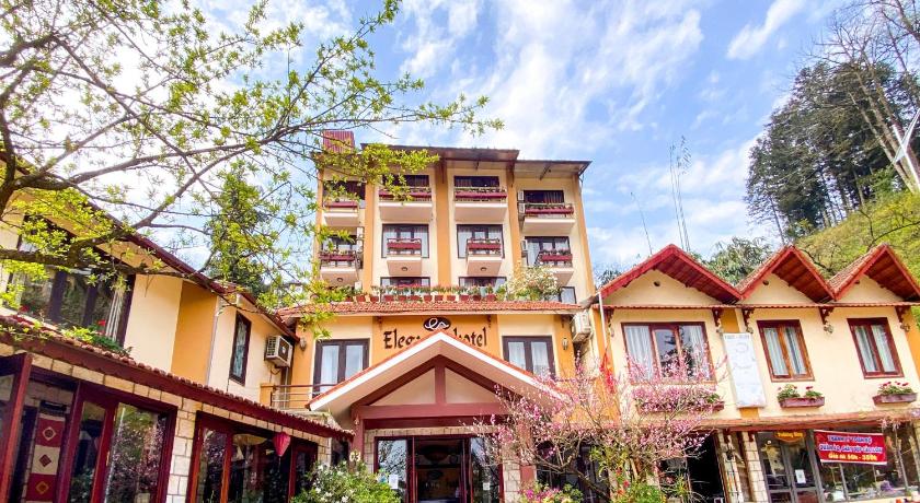 a large brick building with a view of a city, Sapa Elegance Hotel in Sapa