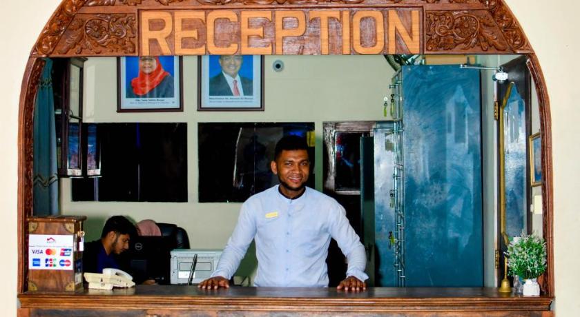 a man standing in front of a counter in a kitchen, Forodhani Park Hotel in Zanzibar