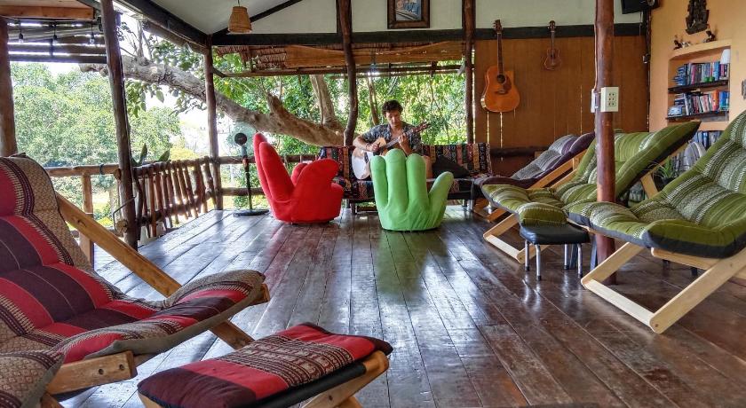 a living room filled with furniture and a table, Tree House Bungalows in Ko Tao