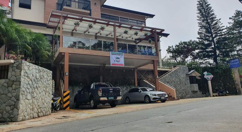 a car parked on the side of a road near a building, Giraffe Boutique Hotel in Baguio