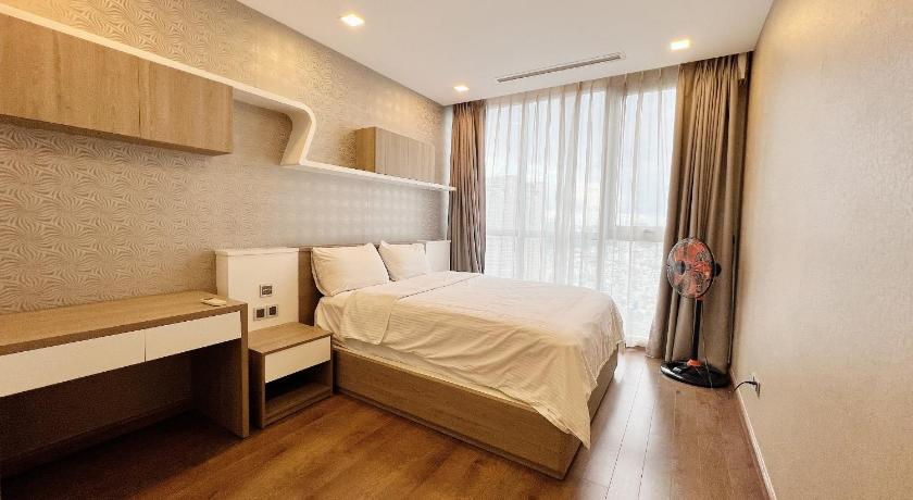a bedroom with a bed and a window, Vinhomes -Christine Luxury Apartments in Ho Chi Minh City