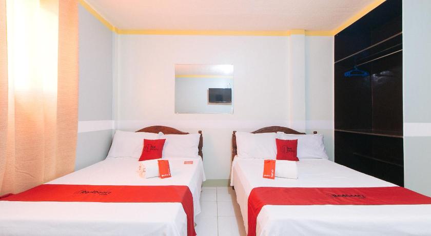 a hotel room with two beds and two lamps, RedDoorz Plus near Bangui Windmills - Vaccinated Staff in Ilocos Norte