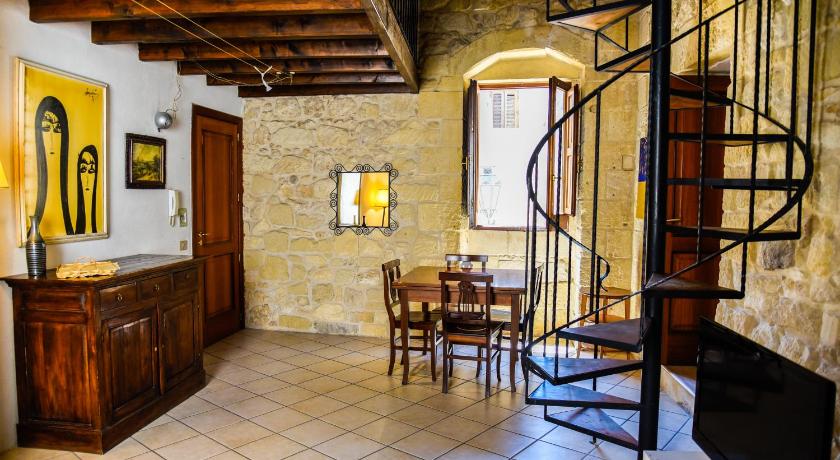a dining room with a staircase leading up to a kitchen, B&B Demetra Appartamenti in Lecce