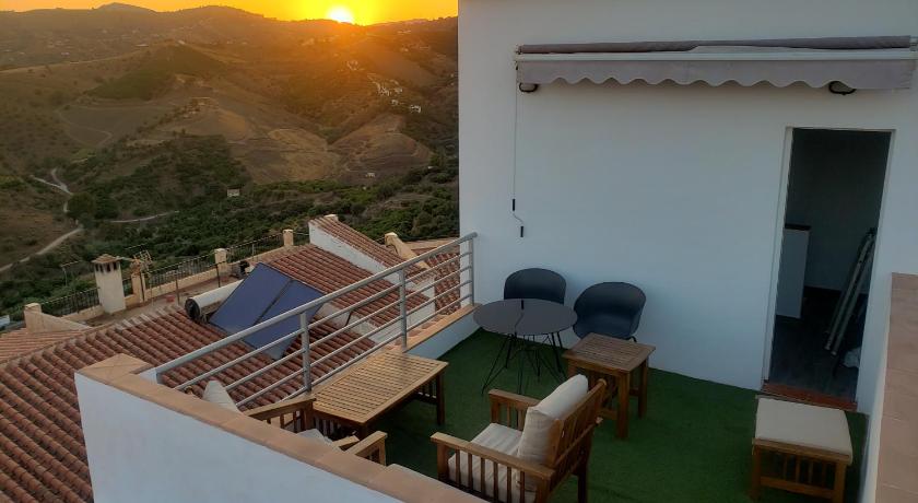 a patio area with chairs, a table, and a balcony, Loft of Love in Nerja