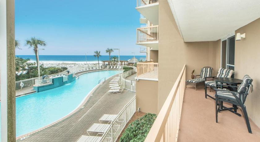 a hotel room with a balcony overlooking the ocean, Pelican Beach Resort 213 in Destin (FL)
