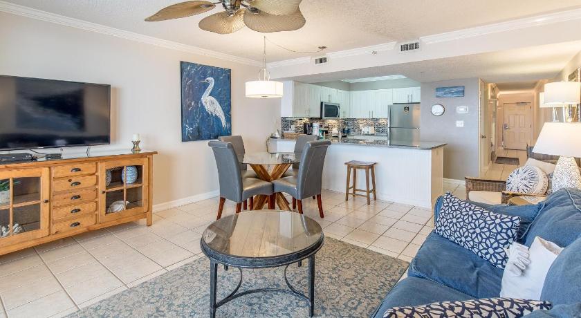 a living room filled with furniture and a table, Pelican Beach Resort 410 in Destin (FL)