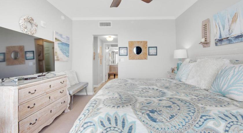a bedroom with a bed and a dresser, St. Lucia 802 by RealJoy Vacations in Destin (FL)