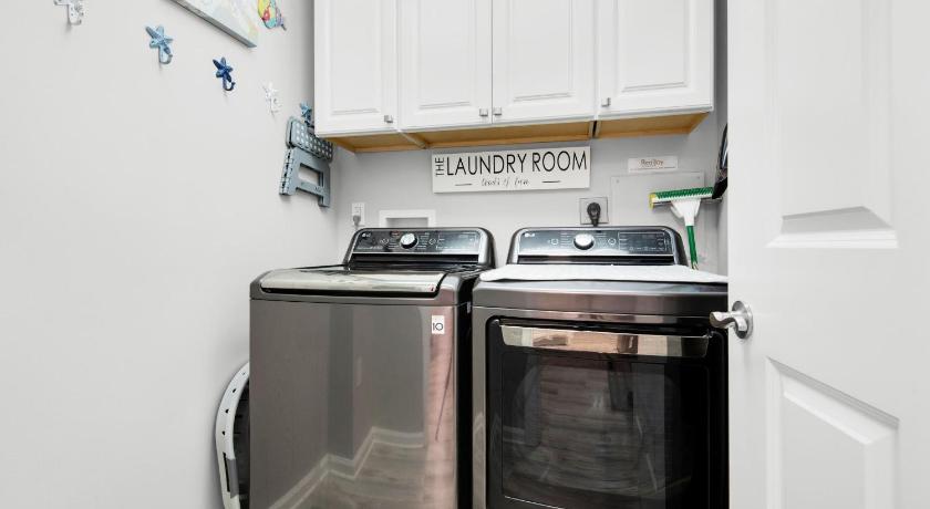 a kitchen with a stove top oven and a microwave, St. Lucia 802 by RealJoy Vacations in Destin (FL)