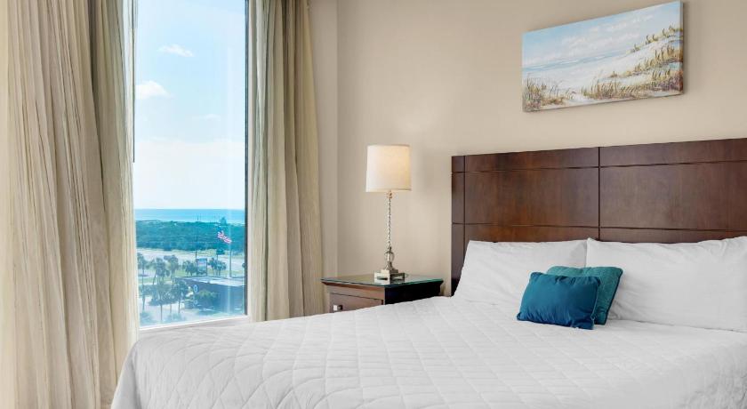 a hotel room with a bed and a window, Palms Resort #1812 by RealJoy Vacations in Destin (FL)