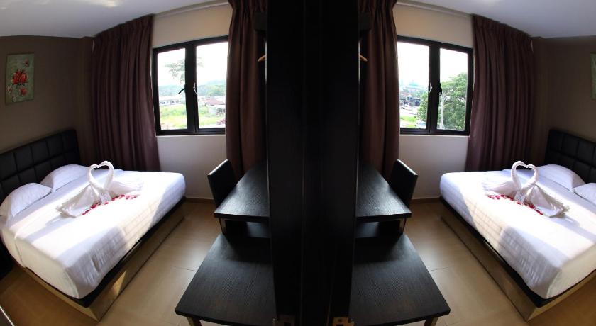 a hotel room with two beds and two tables, GL Hotel in Kluang