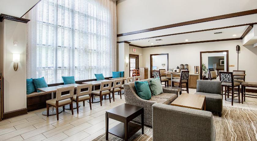 a living room filled with furniture and a large window, Staybridge Suites Gulf Shores in Gulf Shores (AL)