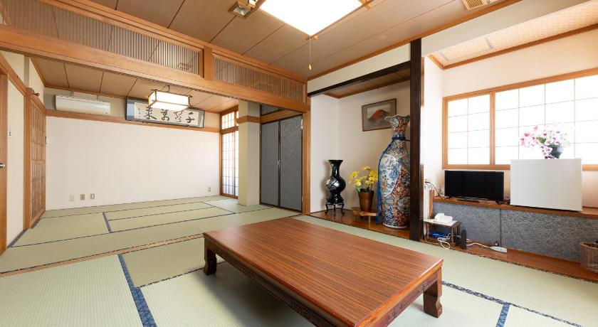a living room filled with furniture and a large window, Tabist Hotel Fuji in Daisen-shi