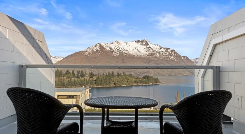a dining room table with a balcony overlooking a lake, Copthorne Hotel and Apartments Queenstown Lakeview in Queenstown