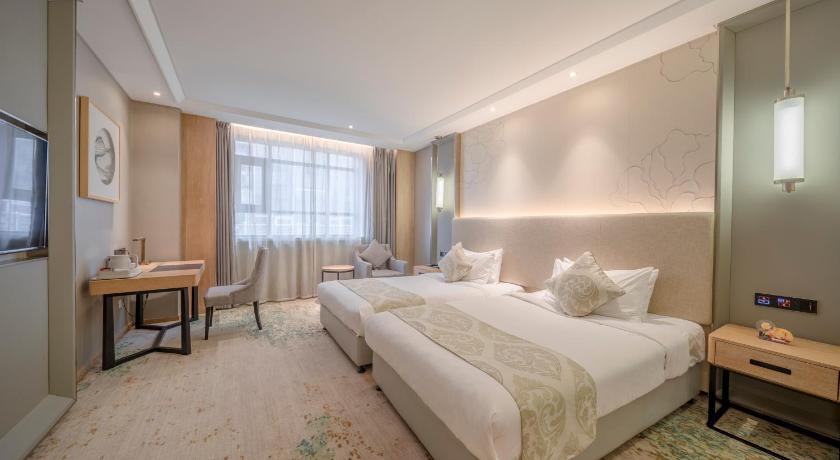 a hotel room with a large bed and a large window, Wuhan Hongguang Hotel in Wuhan