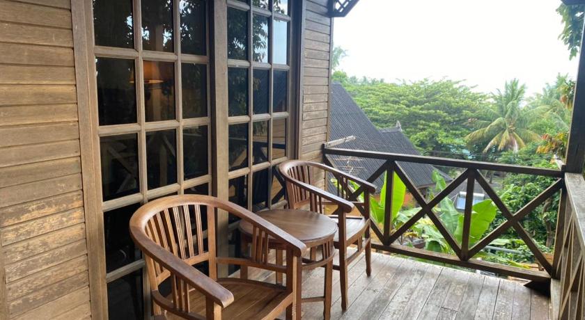 a wooden dining room with a wooden table and chairs, Cozy Resort in Perhentian Islands