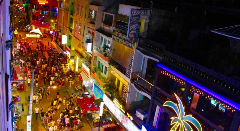 a city street filled with lots of colorful lights, Lucky Homestay Sai Gon in Ho Chi Minh City
