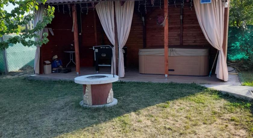 a white toilet sitting in the middle of a grassy area, Vadrozsa Vendeghaz-Apartman in Eger