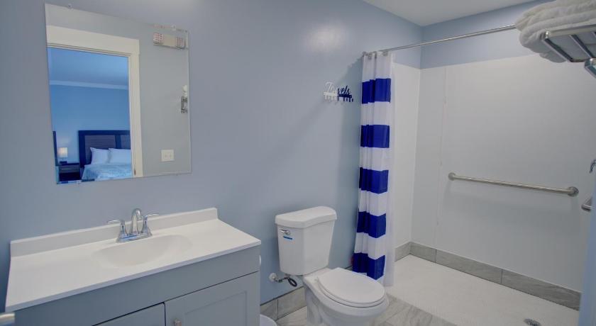 a white toilet sitting next to a sink in a bathroom, Dhimas Bayview Suites - New Building in Ocean City (MD)