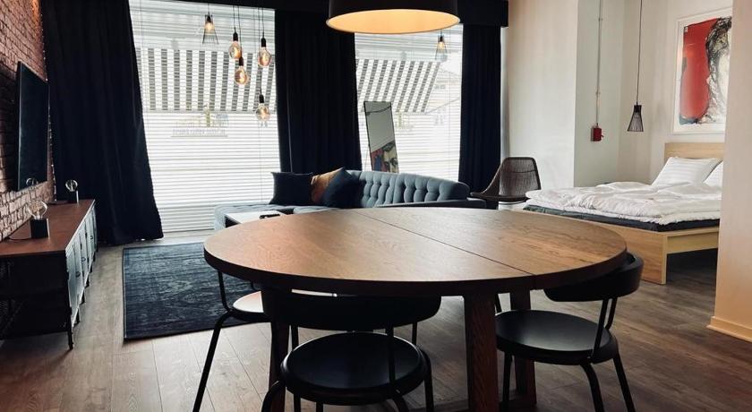 a living room with a table and chairs, Hotel Vanha Rauma in Rauma