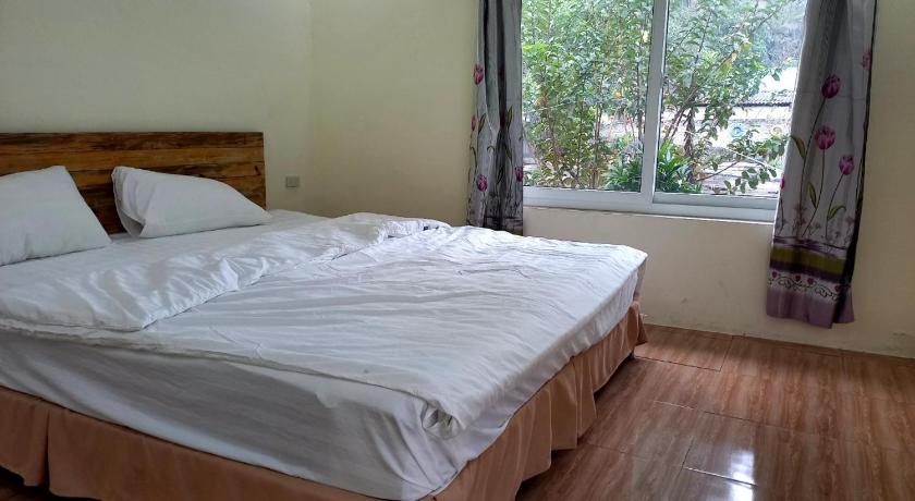 a bedroom with a bed and a window, Trang An Pristine View Homestay in Ninh Bình