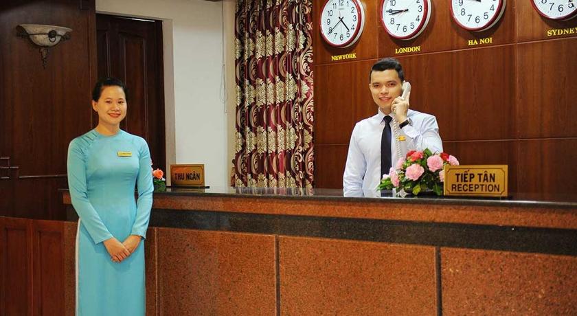 a woman standing next to a man at a counter, T78 Hotel in Ho Chi Minh City