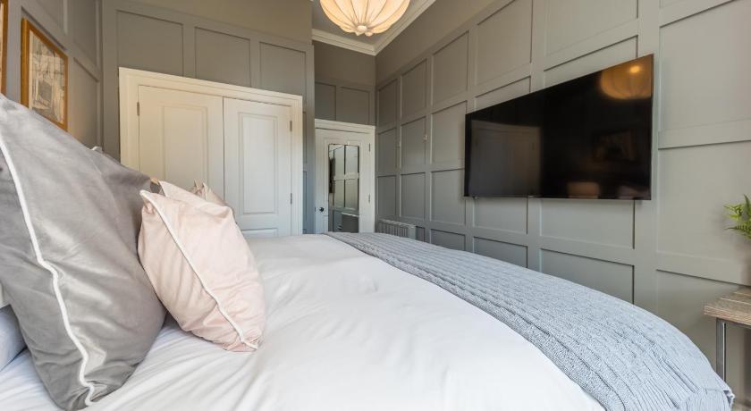 a bedroom with a white bed and white walls, No.1 Apartments - George IV Bridge in Edinburgh