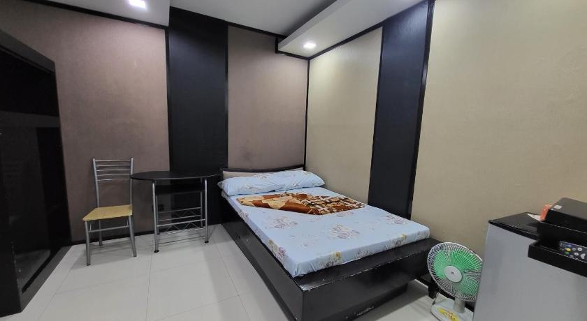 a bedroom with a bed and a dresser, Finteo Skylands in Baguio