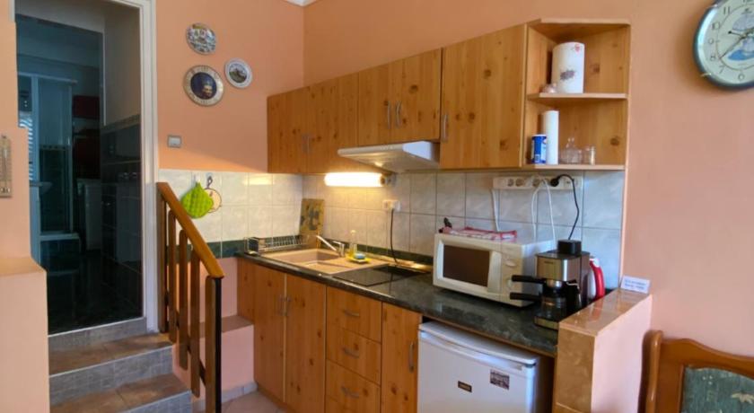 a kitchen with a stove, refrigerator, sink, and cabinets, Sunny & Green in Hévíz