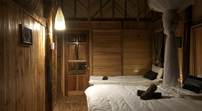 a bedroom with a bed and a night stand, Luckydaisy Buffalo House in Sapa